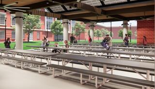 A spacious, open dining area features metal picnic tables, greenery outside, and people interacting in a relaxed, modern setting.
