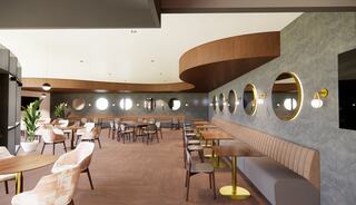 A modern, stylish café features round mirrors, elegant seating, warm wood accents, and a spacious layout with potted plants.