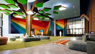A vibrant lobby features colorful murals, playful tree structures, and cozy seating, creating a lively, welcoming atmosphere.