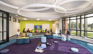 A vibrant, modern learning space features children engaged in various activities on colorful seating, with large windows and a playful design.