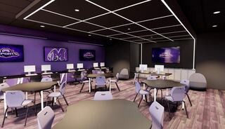 A modern classroom features purple accents, multiple computer stations, and large screens, promoting a tech-friendly learning environment.
