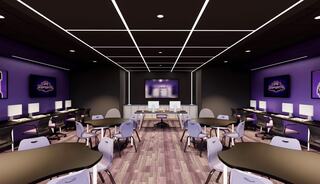A modern esports room features purple accents, computers at desks, and large screens for gaming, creating an engaging tech environment.