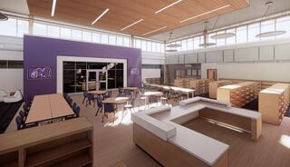 A modern classroom with ample seating, large windows, wooden accents, and organized storage areas, creating a bright learning environment.