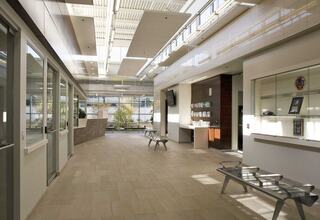 A spacious, contemporary interior featuring large windows, natural light, seating areas, and a welcoming design with modern decor.