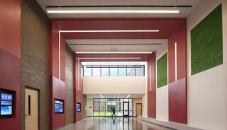 Springman Middle School two story lobby with green moss walls and bold, red wall and ceiling accents