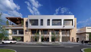 A modern recreation center with a unique architectural design, featuring large windows, wooden accents, and an inviting outdoor area.