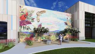 A rec center with a colorful mural featuring wildlife and nature, with people enjoying a landscaped area, surrounded by greenery and modern architecture.