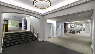 Church entry features stairs leading to the gathering space on the right, creating a welcoming atmosphere.