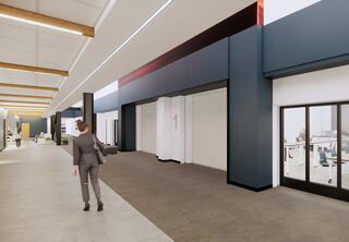 Interior rendering of bottom level of new Technology Education Center at St. Louis Community College Forest Park, designed by FGM Architects, featuring the two-story light-filled "link" and glass-walled classrooms that put learning on display.