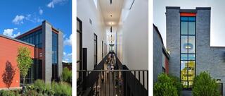 A modern building showcases a striking blend of red and gray materials, featuring large windows and sleek architectural lines.