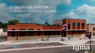 New Elgin, Texas police station and training facility with unique brick and stone masonry details, curved second story windows and FGM Architect's logo (fgma) in the lower right corner.