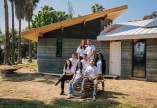 Group of Woodbury University architecture students working on the Solar Futures House during construction progress.