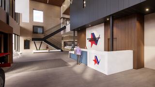 A modern lobby features a sleek reception desk, stairs, and a mix of textures, creating an inviting space with ample natural light.