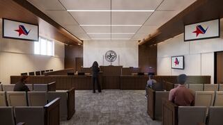 A modern courtroom features wooden accents, a judge's bench, audience seating, and digital displays with a star emblem.