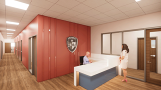 A modern reception area features a welcoming desk, stylish decor, and a logo on the wall, creating a professional atmosphere.