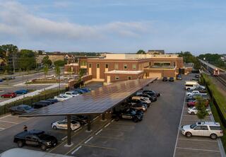 Covered police parking with solar panels on the roof of the parking structure are a key element in the sustainable operations of the new Downers Grove Civic Center