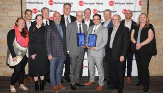 Group Photo with 13 team members from FGM Architects at the 2025 AIA NEI Awards ceremony with two awards