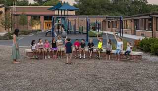 A modern, colorful learning space features cozy seating, vibrant decor, and large windows, creating an inviting atmosphere for students.