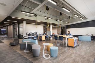A modern, flexible school workspace featuring colorful seating, collaborative areas, and a bright, open layout designed for productivity and creativity.