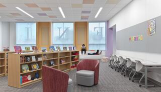 A bright, modern library space features bookshelves, cozy seating areas, and study tables, creating an inviting atmosphere for reading and learning.