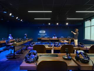 A modern classroom setup features several individuals using virtual reality headsets, engaging in an immersive learning experience.