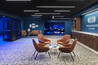 A modern, inviting workspace features cozy seating, a stylish color palette, and a collaborative atmosphere conducive to learning.