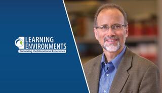 A smiling man in professional attire stands beside a logo promoting educational enhancement through learning environments.