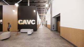 A modern hallway features sleek design elements with bold signage for CAVC and ELEC, alongside minimalist seating and lighting.
