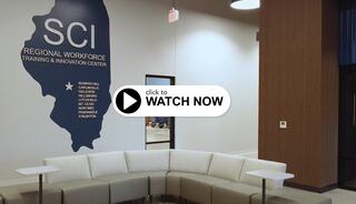 A modern training center features a curved seating area, bright walls, and a map highlighting various locations in Illinois.