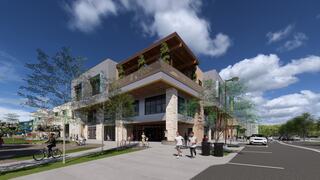 A modern, multi-story building features a mix of stone and glass, with green accents and people enjoying the surrounding outdoor space.