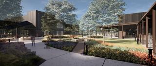 A landscaped area features pathways, vibrant flowers, and modern buildings surrounded by tall trees, creating an inviting outdoor space.