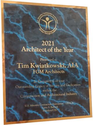 A plaque honors Tim Kwiatkowski, AIA, named 2021 Architect of the Year by the U.S. Minority Contractors Association for outstanding contributions.