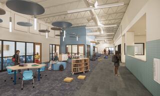 A modern learning space features students engaging in activities at desks and comfortable seating, under bright lighting and a spacious design.