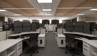 A modern office space featuring multiple workstations, each with several monitors, organized in a neat and open layout.