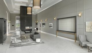 A stylish, modern lounge features gray walls, elegant furniture, and contemporary lighting, creating a sophisticated and inviting atmosphere.