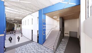 A modern school interior features a spacious entrance, stairs leading to upper levels, and students engaging in the open area.