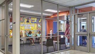A bright, modern waiting area features children seated, colorful artwork on the wall, and an American flag visible through glass doors.