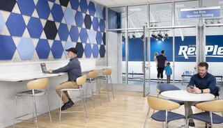 A modern space features a geometric wall, two people seated with devices, and families entering an ice rink for spectator seating.