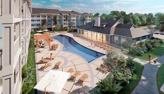 A modern apartment complex features a large pool surrounded by lounge chairs, lush landscaping, and a stylish clubhouse, all under a bright sky.