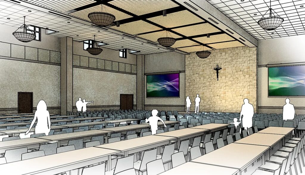 A large, spacious hall with rows of tables and chairs, featuring modern lighting, a stone wall, and digital displays. People are present.