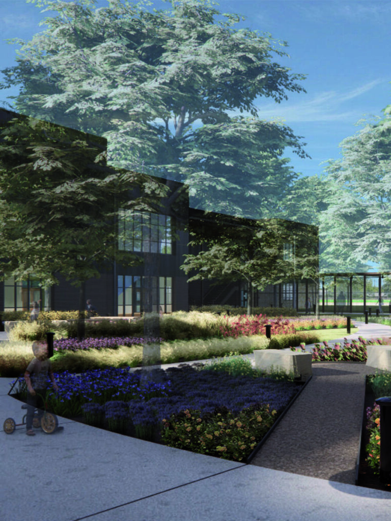 A vibrant garden pathway with colorful flowers leads to a modern building, framed by lush trees and a clear blue sky. A child rides a tricycle.