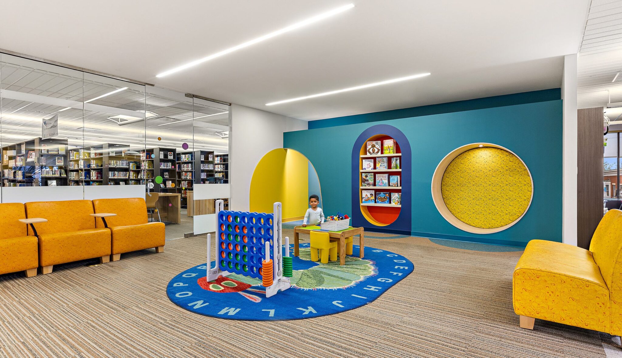 A bright children's reading nook features colorful seating, playful decor, and a cozy area for books and activities, promoting a joyful learning space.