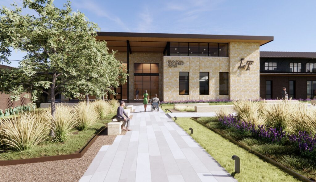 A modern building features large windows and a welcoming entrance, surrounded by landscaped gardens and walking paths, promoting community interaction.