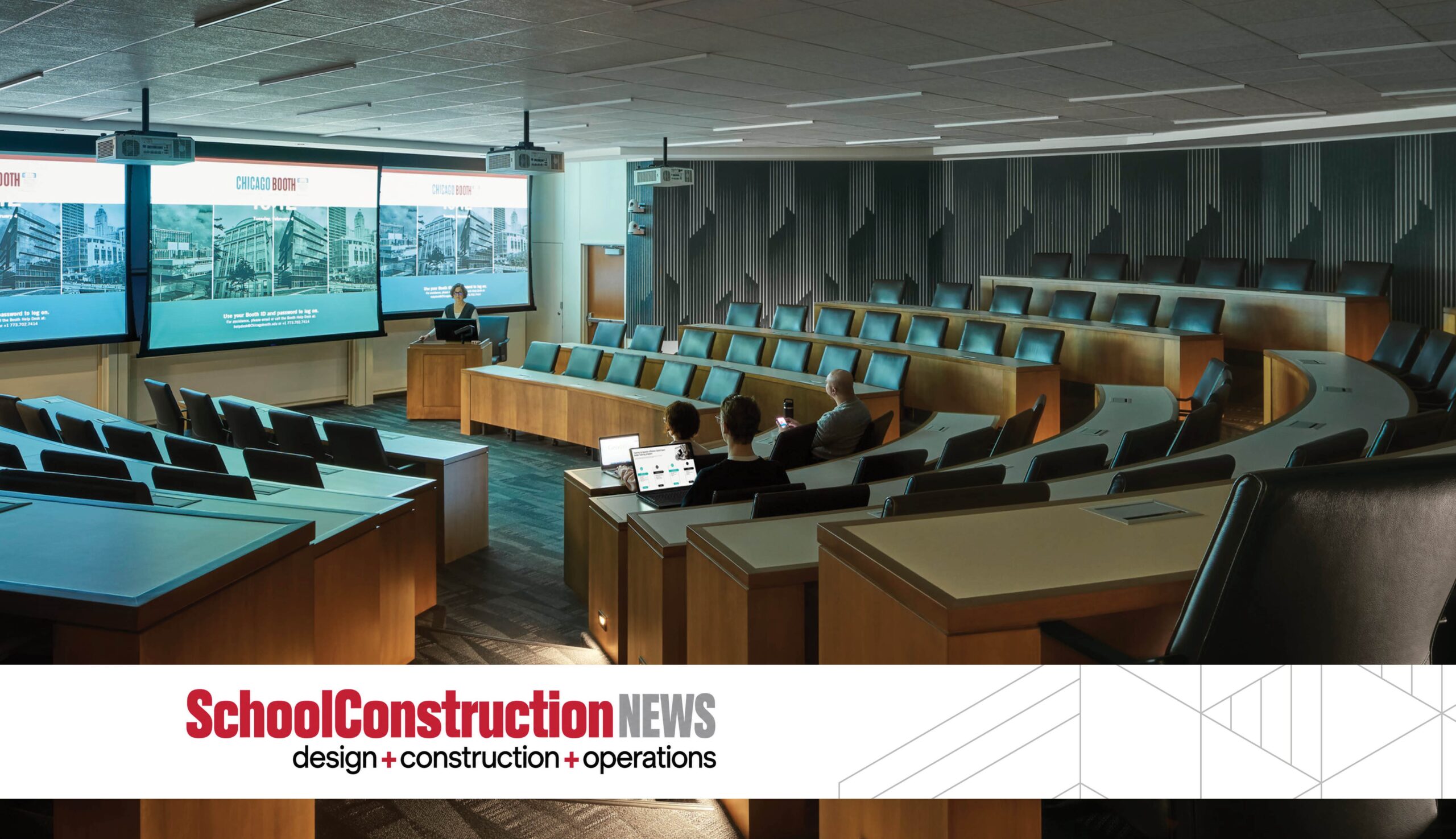 A modern lecture hall with tiered seating, large screens, and a sleek design, designed for presentations and collaborative learning.